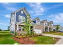 Beautiful brick two-story home boasting a manicured lawn, landscaping, and an attached two-car garage at 10132 Whitaker Pointe Dr, Huntersville, NC 28078