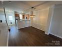 Open dining room with hardwood floors and kitchen view at 10515 Rocky Ford Club Rd, Charlotte, NC 28269