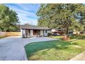 Modern, renovated home with a large concrete driveway at 4132 Shamrock Dr, Charlotte, NC 28215