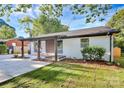 Charming ranch home with a white brick exterior and covered porch at 4132 Shamrock Dr, Charlotte, NC 28215