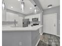 Modern kitchen with white cabinets, quartz countertops, and stainless steel appliances at 14307 San Paolo Ln # 5102, Charlotte, NC 28277