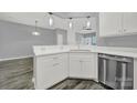 White kitchen cabinets and quartz countertops, stainless steel dishwasher at 14307 San Paolo Ln # 5102, Charlotte, NC 28277