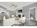 Virtually staged living room with fireplace, modern furniture, and an open floor plan at 14307 San Paolo Ln # 5102, Charlotte, NC 28277