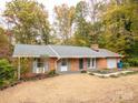 Charming brick home featuring a manicured lawn, classic design, and attached garage at 110 Mimosa Rd, Statesville, NC 28677