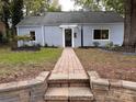 Inviting home with a well-manicured lawn and charming brick walkway at 131 Glendale Se Ave, Concord, NC 28025
