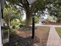 Landscaped front yard featuring a lamp post, mulch beds and a brick walkway at 131 Glendale Se Ave, Concord, NC 28025