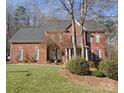 Two-story brick house with a manicured lawn and mature trees at 3481 Fieldstone Dr, Gastonia, NC 28056