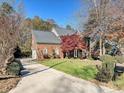 Brick home with a long driveway and lush landscaping at 3481 Fieldstone Dr, Gastonia, NC 28056