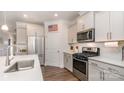 Modern kitchen with stainless steel appliances and quartz counters at 5043 Antebellum Dr, Iron Station, NC 28080