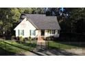 Charming home with manicured front lawn and welcoming front porch area and black metal fence at 1000 Hunting Ave, Lincolnton, NC 28092