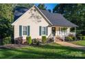 Lovely home with neat landscaping and an inviting front porch with black shutters and trim at 1000 Hunting Ave, Lincolnton, NC 28092