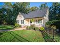 Charming home with a lush front yard, complemented by a picket fence and mature trees at 1000 Hunting Ave, Lincolnton, NC 28092