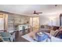 Living room featuring a rustic wood wall and comfortable seating at 7324 Friar Tuck Ln, Mint Hill, NC 28227