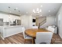 Kitchen and dining area with light hardwood floors and round table at 112 Atterberry Aly, Charlotte, NC 28217