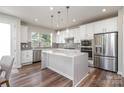 Modern kitchen with white cabinets, stainless steel appliances, and island at 112 Atterberry Aly, Charlotte, NC 28217