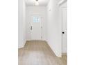 Bright foyer with wood-look floors and neutral paint leads into other areas of the house at 337 Autumn Dr, Harrisburg, NC 28075