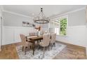 Elegant dining room with a modern chandelier and wainscoting at 1025 Readsboro Dr # 11, Mt Ulla, NC 28125