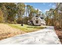Scenic view of the home's exterior showing the driveway, side entrance, and a wooded backdrop at 1025 Readsboro Dr # 11, Mt Ulla, NC 28125