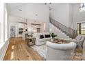 Open-concept living space featuring hardwood floors, a staircase, and a seamless transition to the kitchen at 1025 Readsboro Dr # 11, Mt Ulla, NC 28125
