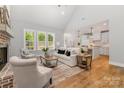 Bright and airy living room with large windows, modern decor, a brick fireplace, and an open-concept layout at 1025 Readsboro Dr # 11, Mt Ulla, NC 28125