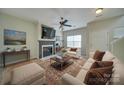 Cozy living room with a fireplace, a TV, a ceiling fan and comfortable seating at 1111 Constitution Park Blvd, Rock Hill, SC 29732