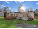 Charming ranch-style home featuring a welcoming front porch, shutters and well-maintained lawn at 1812 Shearers Rd, Davidson, NC 28036