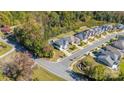 An aerial view of a house with a pool in a suburban neighborhood with sidewalks at 2657 Cheverny Pl, Concord, NC 28027