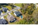 Aerial view of a home with a pool and patio in a wooded neighborhood at 2657 Cheverny Pl, Concord, NC 28027