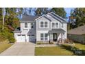 Charming two-story home with a stone accent, two-car garage, and well-manicured lawn at 2657 Cheverny Pl, Concord, NC 28027