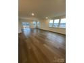 Spacious living room with luxury vinyl flooring and lots of natural light at 3010 Cunningham Farm Dr, Indian Trail, NC 28079