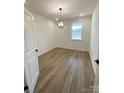 Bright bedroom with hardwood floors and a modern light fixture at 3014 Cunningham Farm Dr, Indian Trail, NC 28079