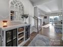 Inviting foyer with stylish decor, leading to a bright and open living space with hardwood floors at 7248 Waterwheel Sw St, Concord, NC 28025