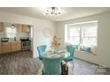 Bright dining area with a glass table, stylish chairs, and window seating located adjacent to the kitchen at 106 S Inman Ave, Bessemer City, NC 28016