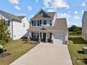 Inviting two-story home with a well-maintained lawn, front porch and integrated one car garage at 1109 Freeman View Dr, Albemarle, NC 28001