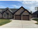 Charming brick home with a two-car garage, manicured lawn, and inviting curb appeal at 3335 48Th Ne Ave # 13B, Hickory, NC 28601