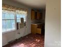 Retro kitchen featuring linoleum flooring, a retro countertop, and a bright window at 1424 Montana Dr, Charlotte, NC 28216