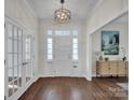 Elegant entryway with hardwood floors, a chandelier, and French doors at 301 S Washington St, Monroe, NC 28112