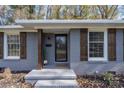 Brick ranch home with gray paint, wood shutters, and landscaping at 5731 Brookhaven Rd, Charlotte, NC 28210