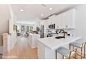 Bright kitchen boasts white cabinets, stainless steel appliances, a center island, and an open layout at 2035 Belmont Terraces Ln # 5, Charlotte, NC 28205