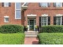 Brick home with a green door and well-manicured landscaping at 4813 Cambridge Crescent Dr, Charlotte, NC 28226