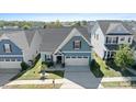 Two-story house with a gray roof, two-car garage, and a small front yard at 50143 Robins Nest Ln, Lancaster, SC 29720