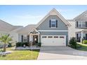 Two-story home with gray siding, white trim, and a two-car garage at 50143 Robins Nest Ln, Lancaster, SC 29720