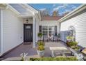 Cozy front porch featuring a seating area and decorative plants, perfect for relaxing outdoors at 10080 Highland Creek Cir, Indian Land, SC 29707