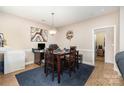Cozy dining room with seating for four, featuring modern decor and warm lighting at 11264 Hyde Pointe Ct, Charlotte, NC 28262