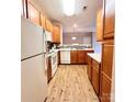 Well-lit kitchen with wood cabinets, white appliances, and a tiled backsplash at 11264 Hyde Pointe Ct, Charlotte, NC 28262