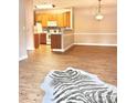 Open-concept living area with wood floors connecting to the kitchen at 11264 Hyde Pointe Ct, Charlotte, NC 28262