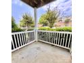 A peaceful patio with white railings and views of green trees and landscaping at 11264 Hyde Pointe Ct, Charlotte, NC 28262