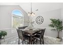 Bright dining room with modern chandelier, large window, and luxury flooring at 6909 Green Haven Ln, Monroe, NC 28110