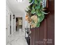 Inviting entryway featuring marble floors, neutral walls, and an ornate front door decoration at 6909 Green Haven Ln, Monroe, NC 28110
