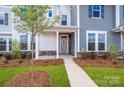 Inviting front entrance with a charming walkway and a well-manicured yard, complemented by lush landscaping at 10105 Mamillion Dr, Huntersville, NC 28078
